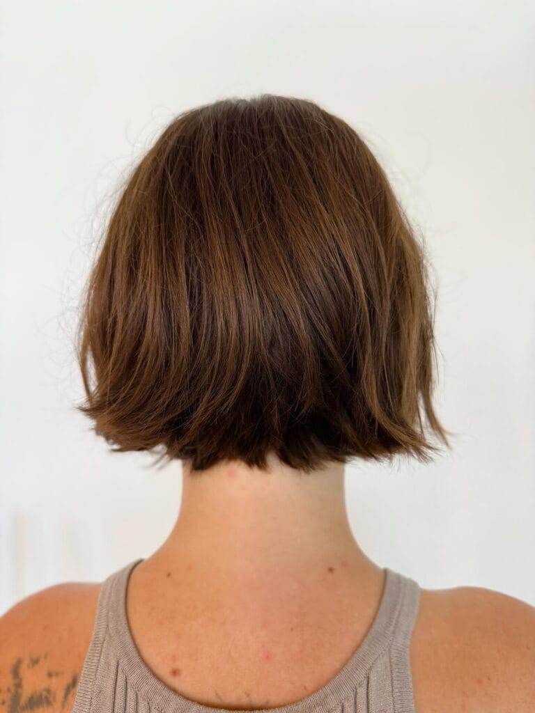 Chin-length blunt bob on straight hair with slightly textured ends and natural brown tones for a clean, classic shape.
