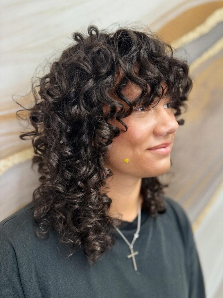 Short curly shag with layered texture and soft loose curls.