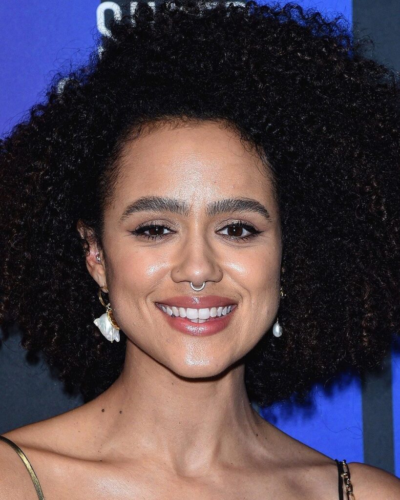 Natural curly hairstyle with full volume and a rounded shoulder length shape.