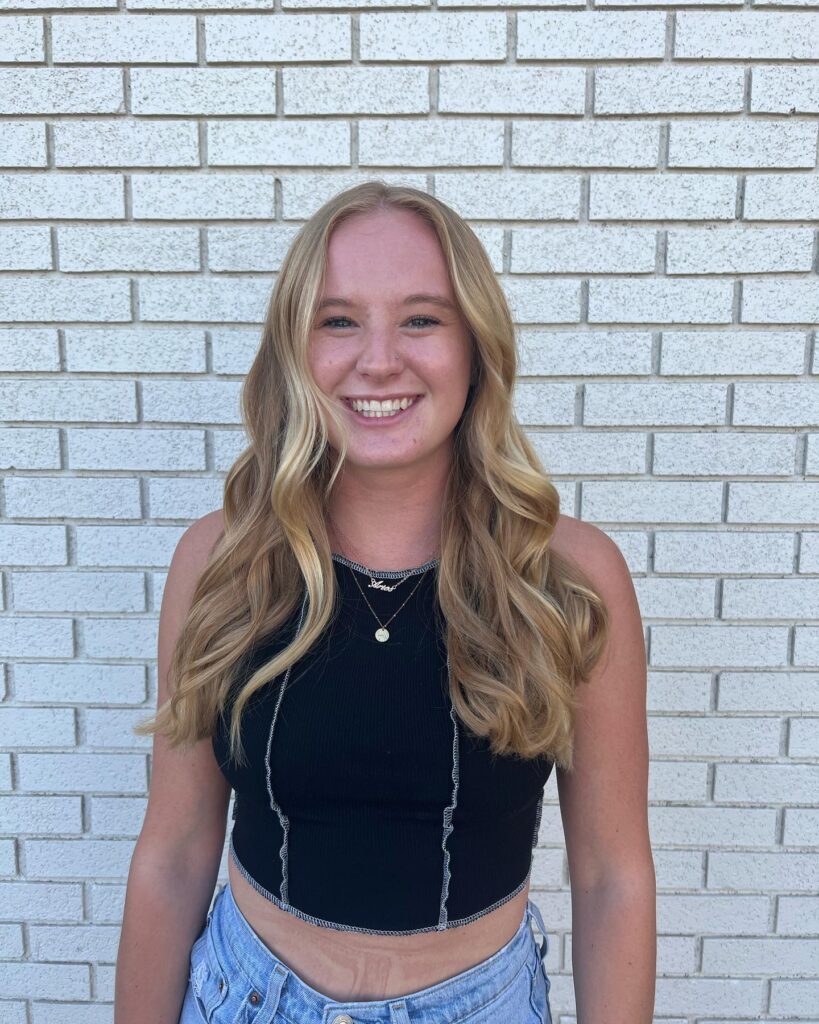 Long blonde hair with loose waves and soft natural looking highlights.
