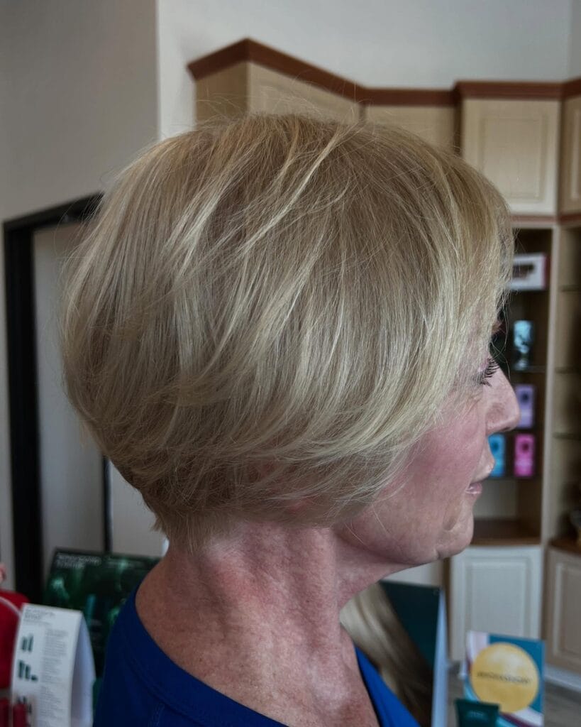 Short layered blonde crop with a rounded shape and soft volume at the back.