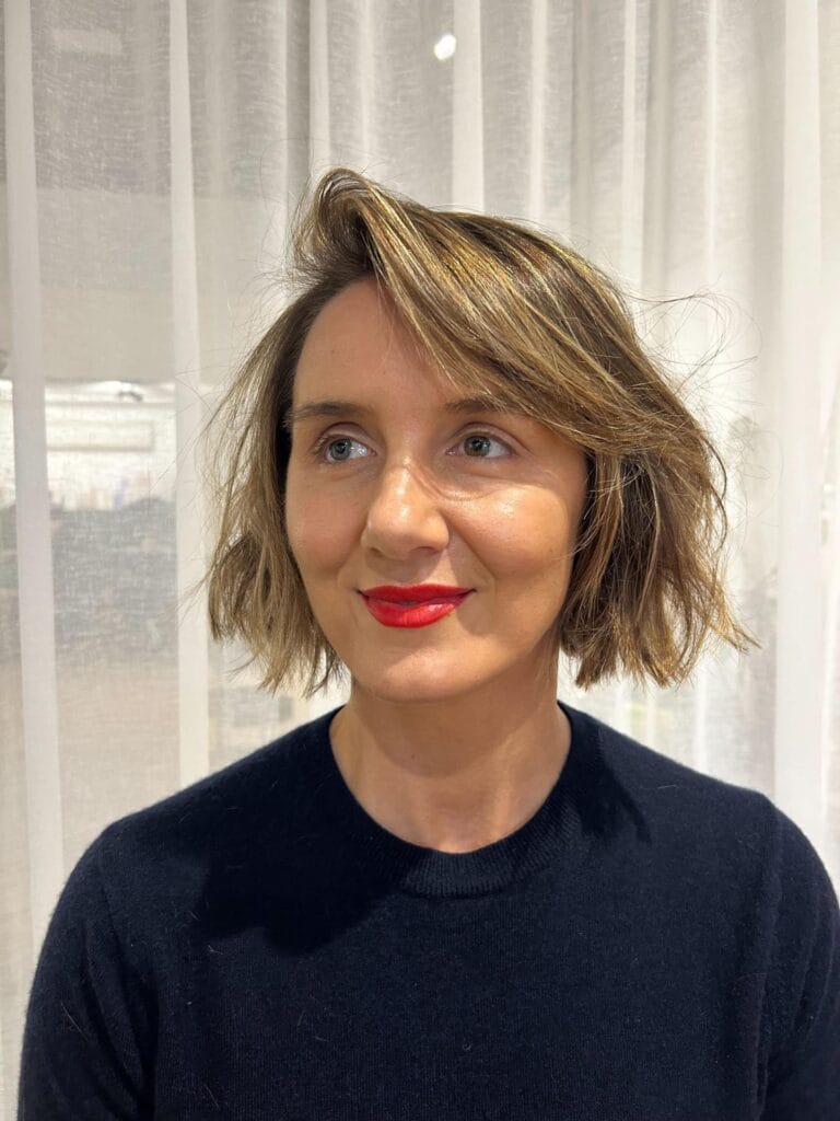 Short textured bob with a side part and soft movement.