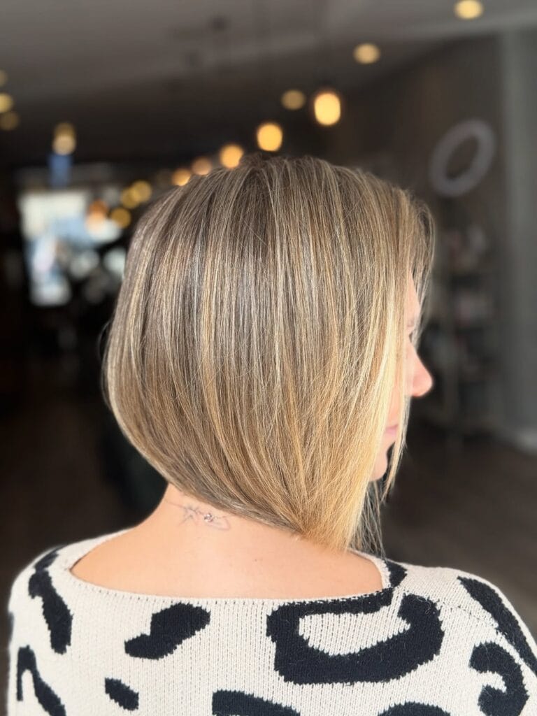 Angled blonde bob with longer front pieces and a smooth finish.