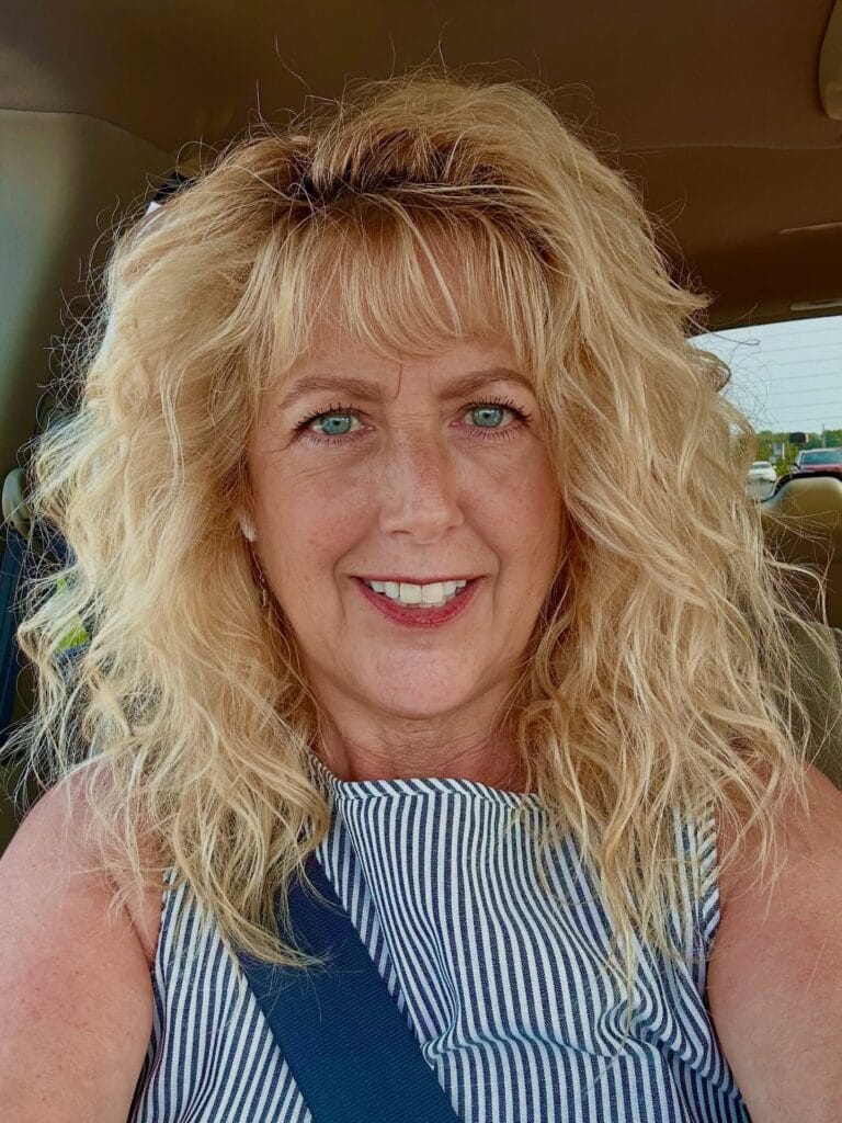 Shoulder length blonde layered hair with natural texture and soft movement.
