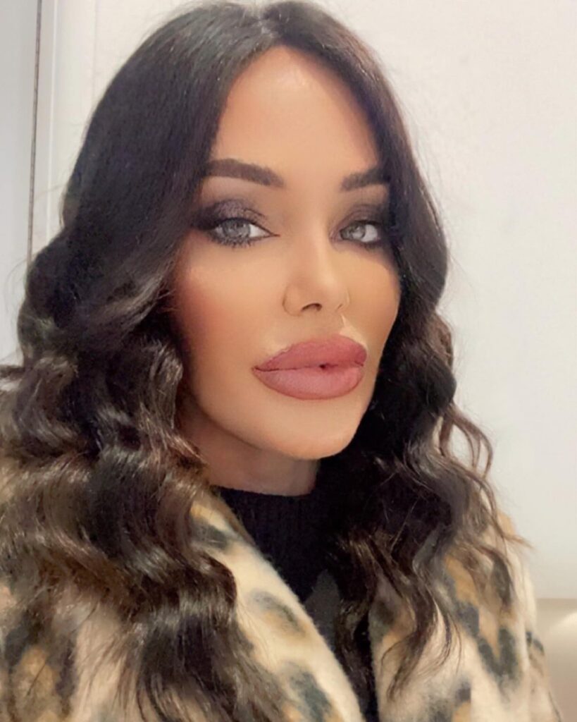 A woman with long, dark espresso hair styled in glamorous middle-parted waves.