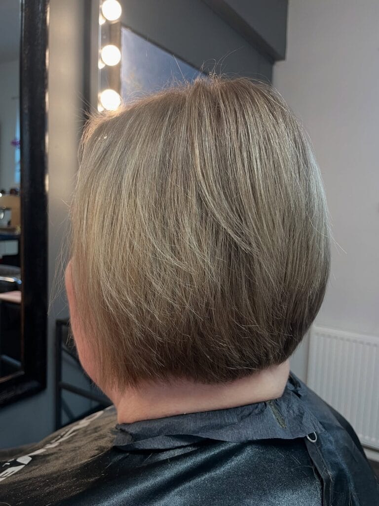 Short gray bob with a tapered back and clean neckline.