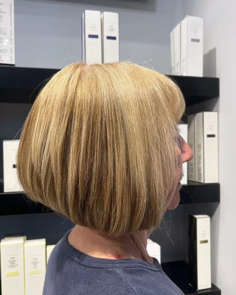 Rounded blonde bob with smooth styling and tucked under ends.