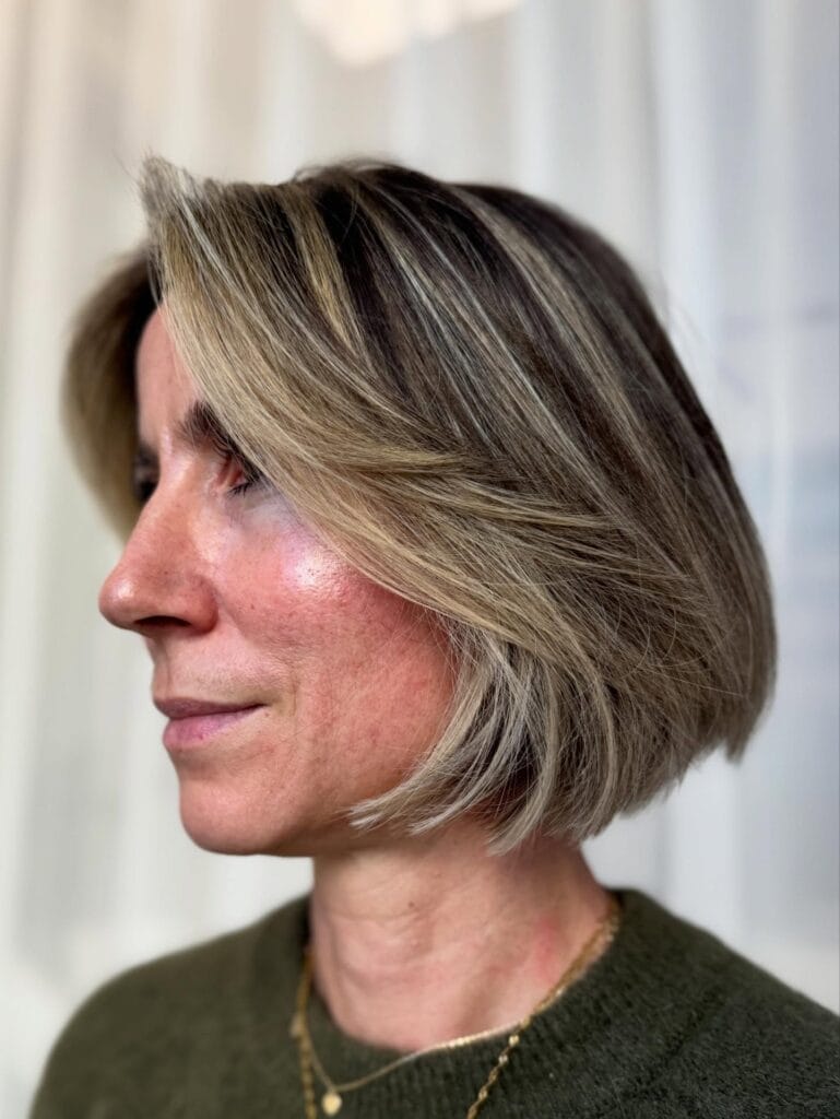 Layered blonde bob with a soft side sweep and natural movement.