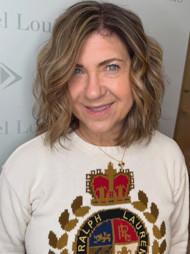 Medium length wavy bob with soft layers and subtle highlights.