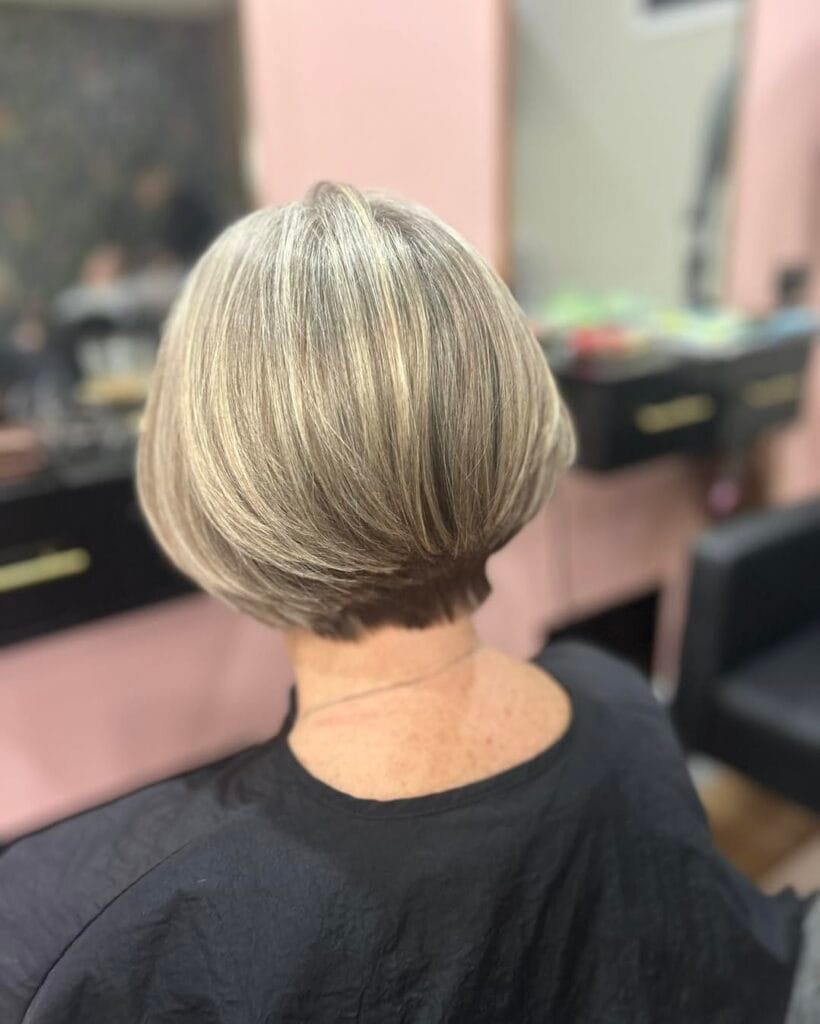 Short tapered silver bob with soft volume and a clean neckline.