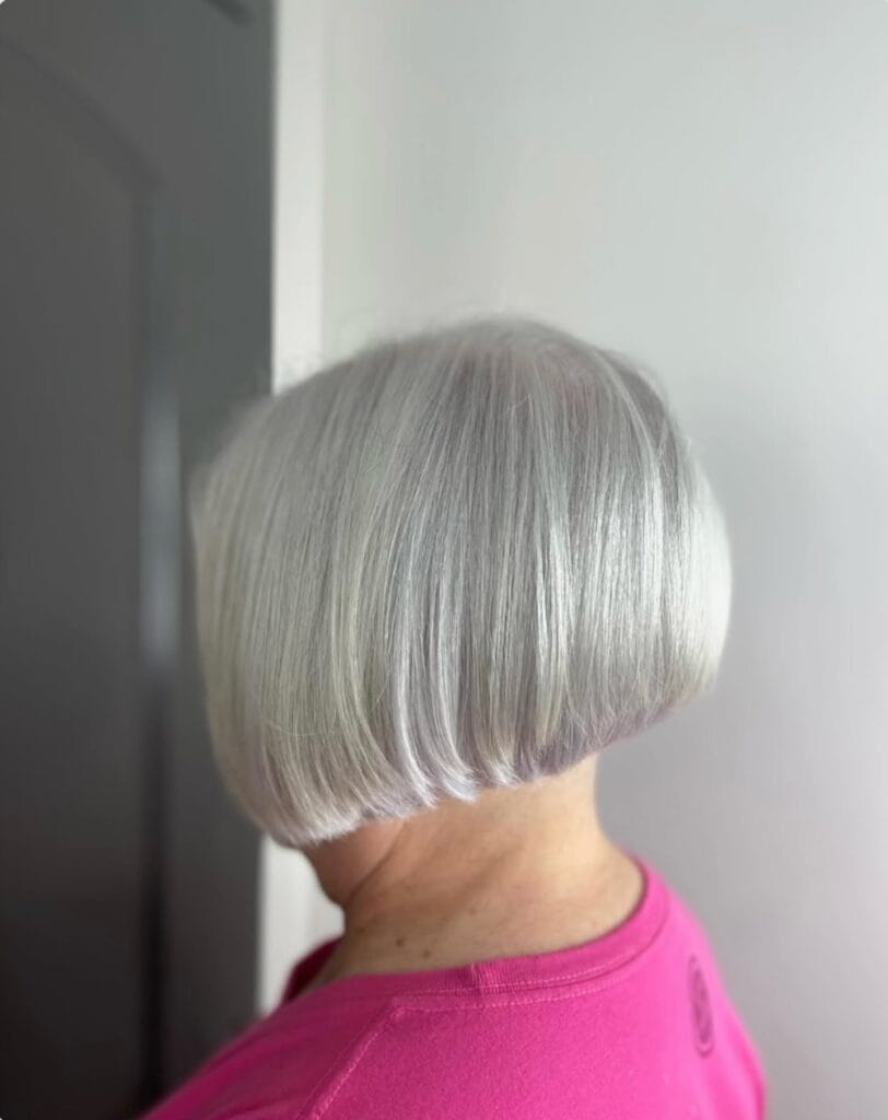 Short rounded silver bob with a blunt fringe and smooth sculpted shape.