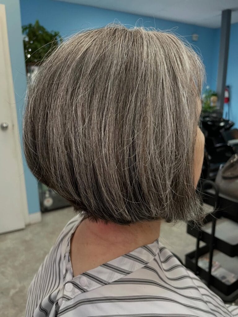 Short rounded gray bob with soft layers and a smooth tucked under finish.