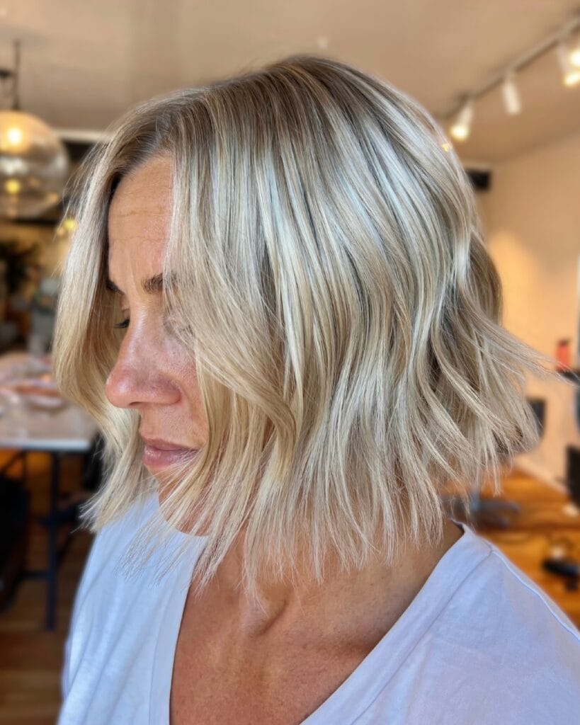 Wavy blonde bob with soft layers and a textured beachy finish.