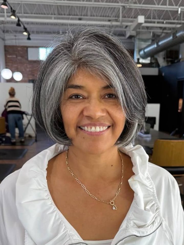 Chin length gray bob with soft layers and a gently curved shape.