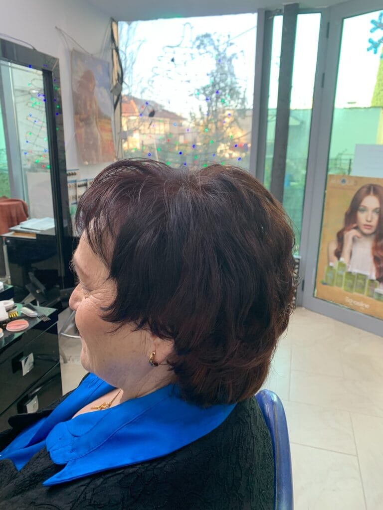 Short brunette bob with soft volume and a rounded layered shape.