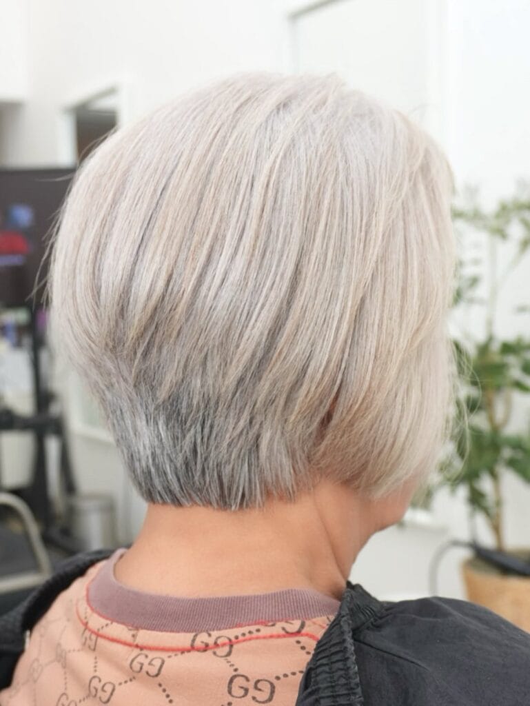 Short gray bob with layered shape and a tapered back.