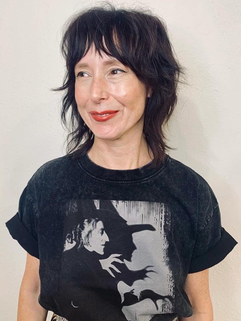 Textured shaggy bob with choppy fringe and layered ends.