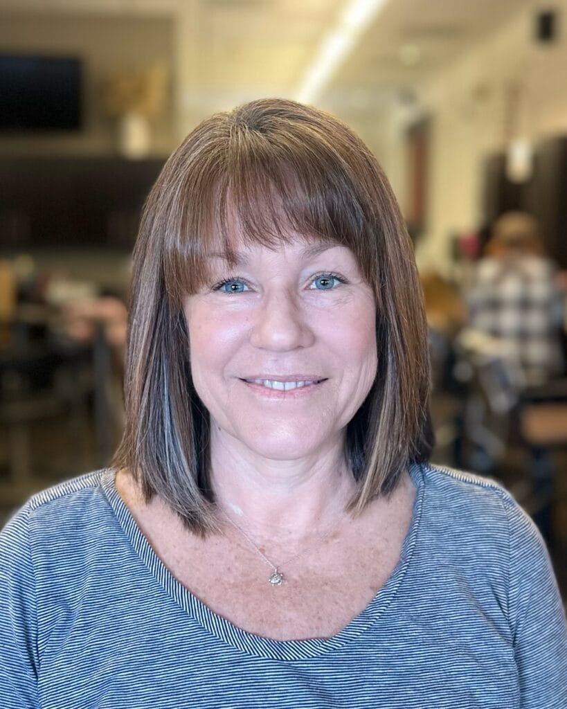 Straight bob haircut with full blunt fringe and smooth finish.