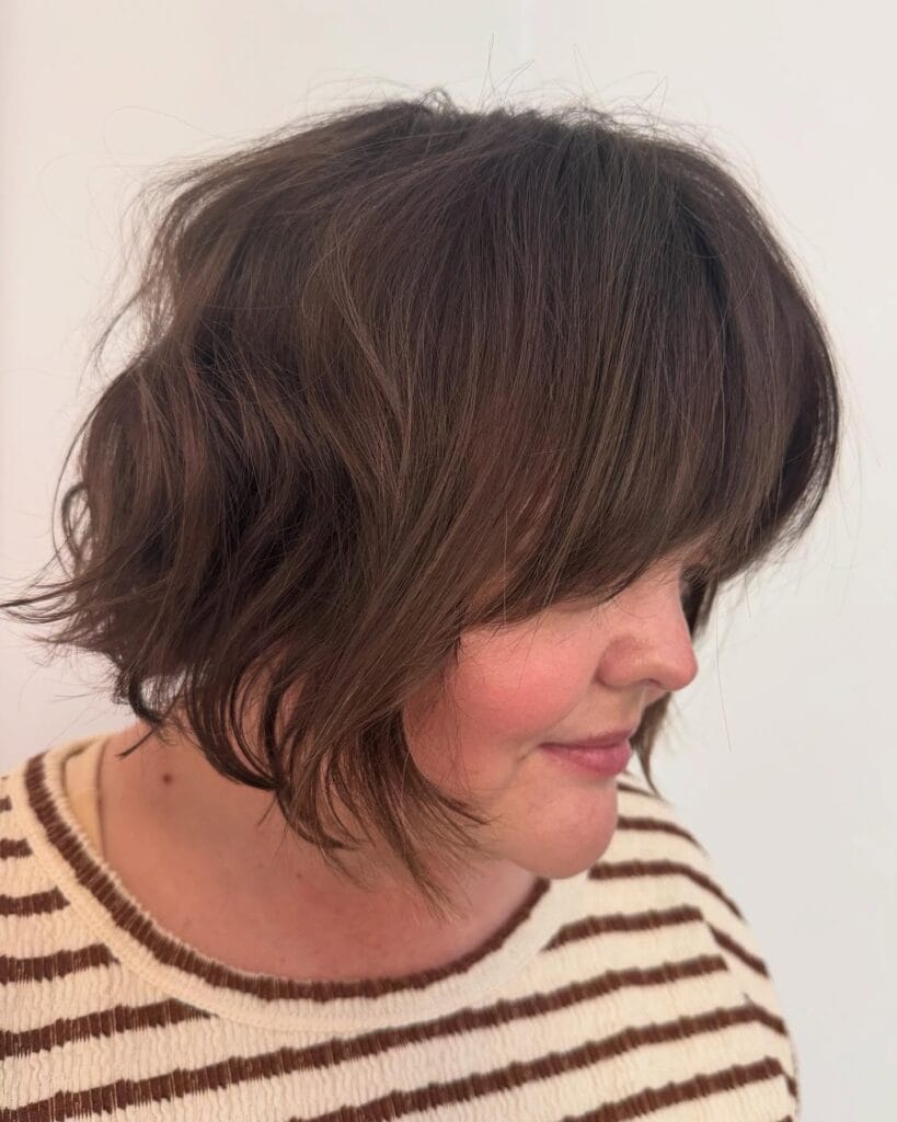 Layered bob with side fringe and soft textured brown layers.