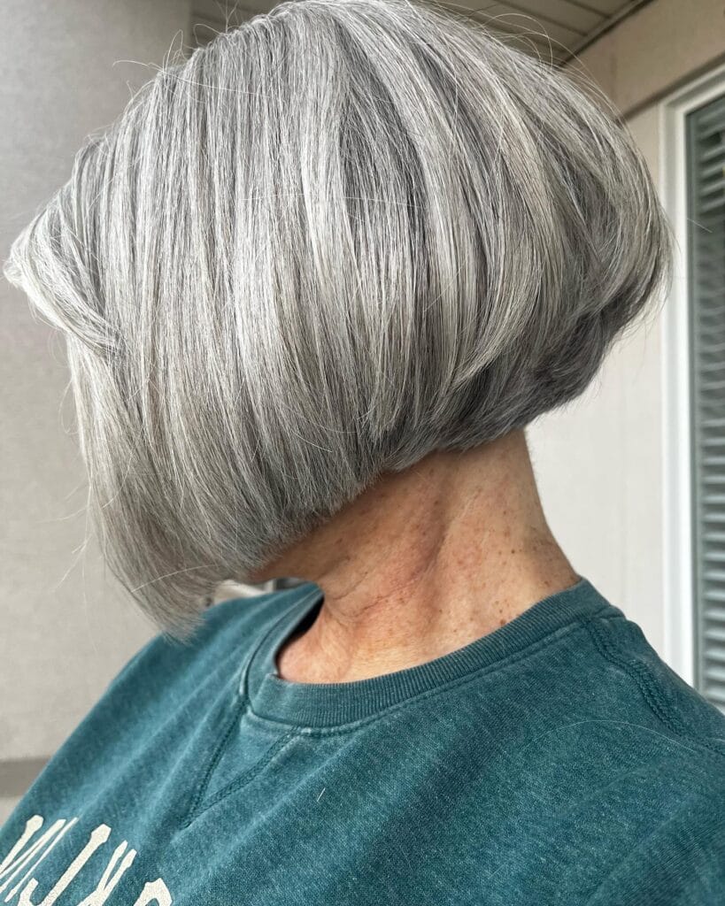 Rounded silver bob with full volume and a soft fringe.
