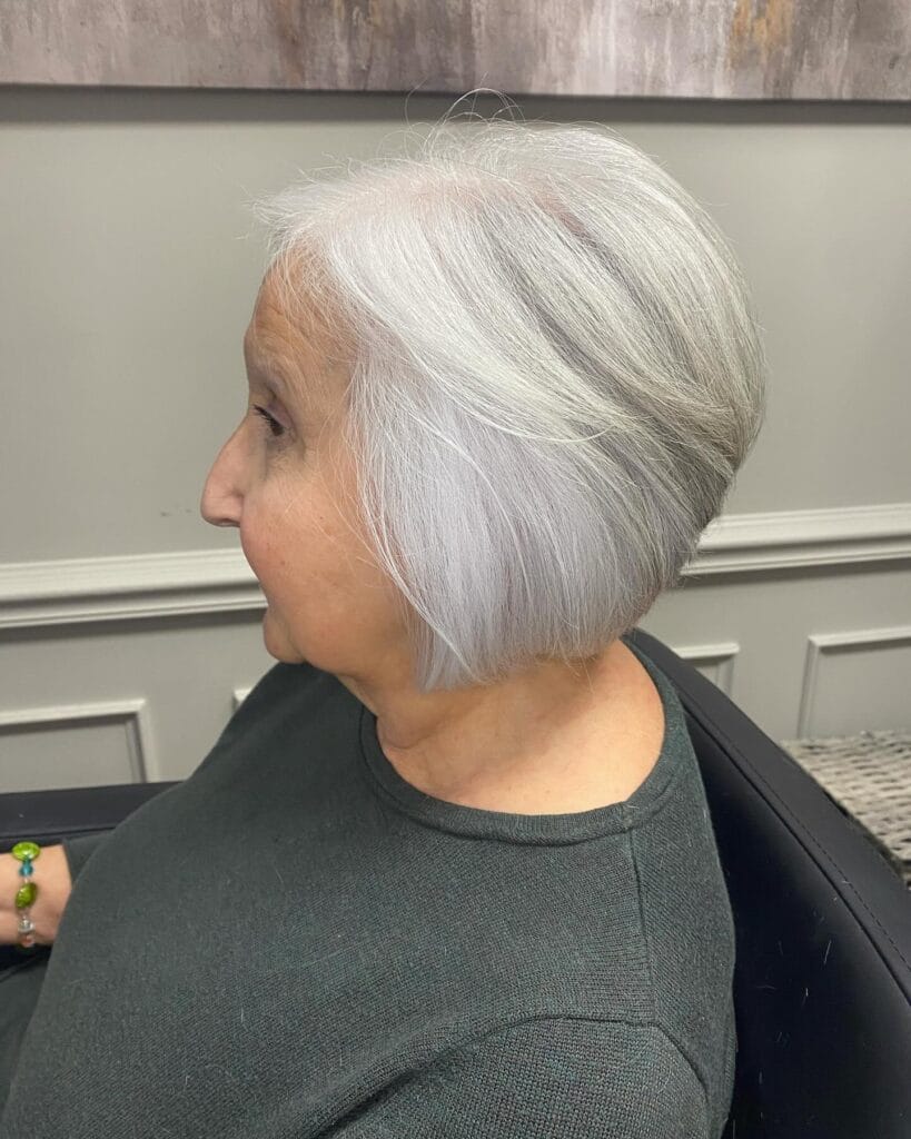 Graduated gray bob with a stacked back and soft blended bangs.