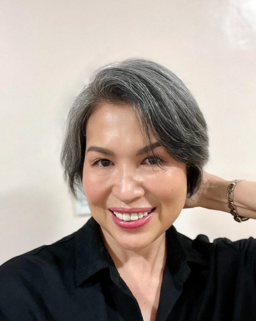 Sleek gray bob with a side part and soft blended bangs.