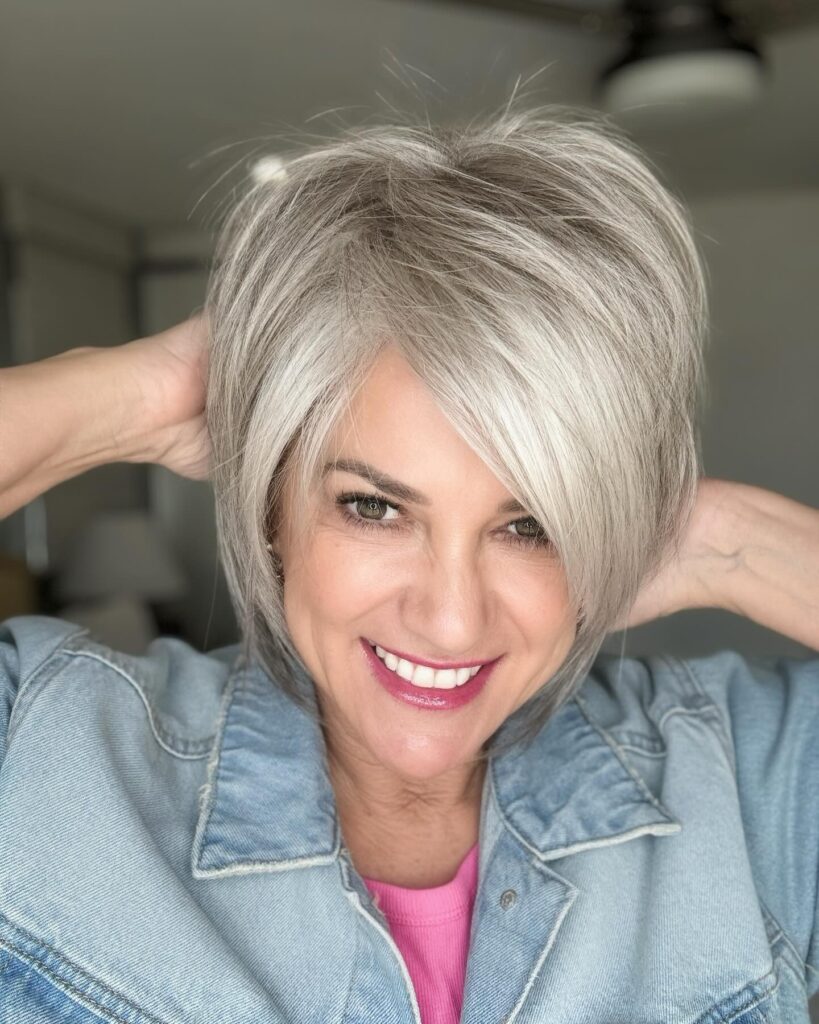 Textured silver bob with side swept bangs and soft layered shape.