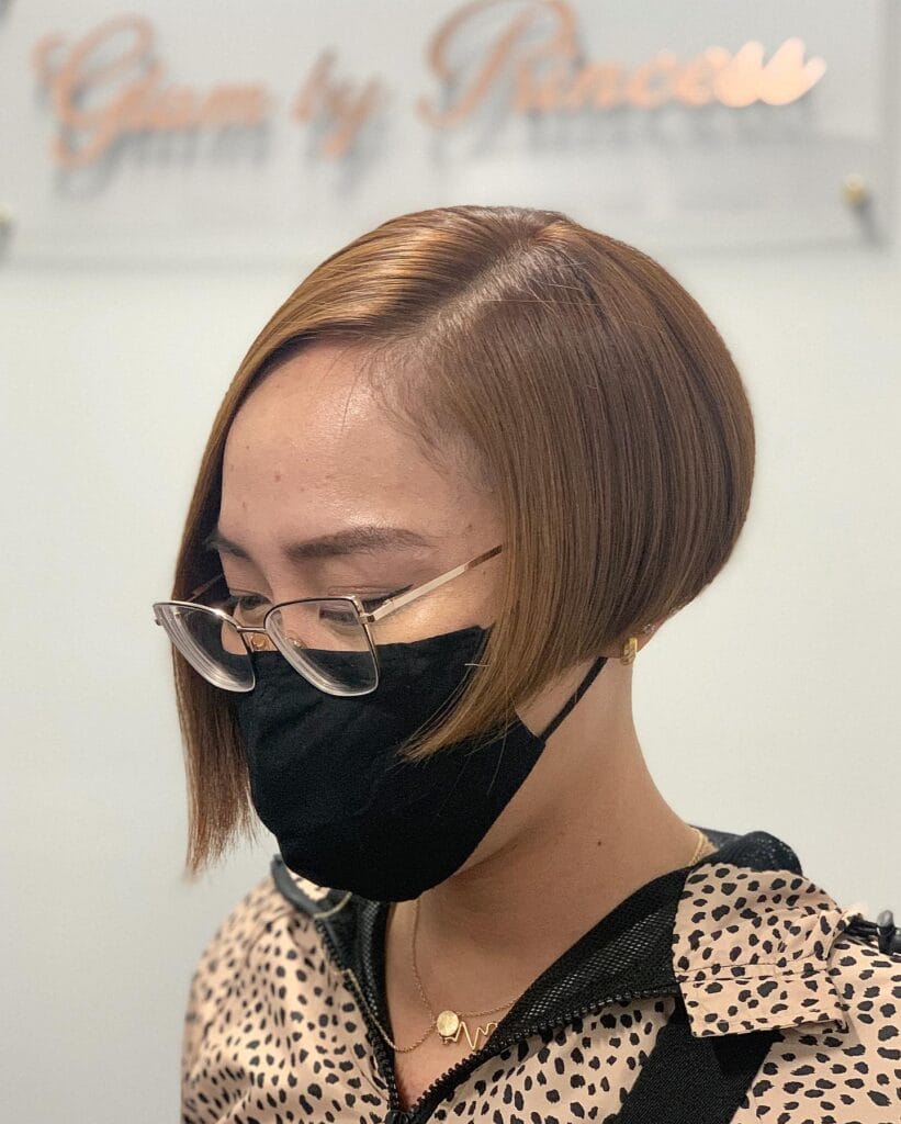 Asymmetrical chestnut inverted bob with a short back and longer front section.