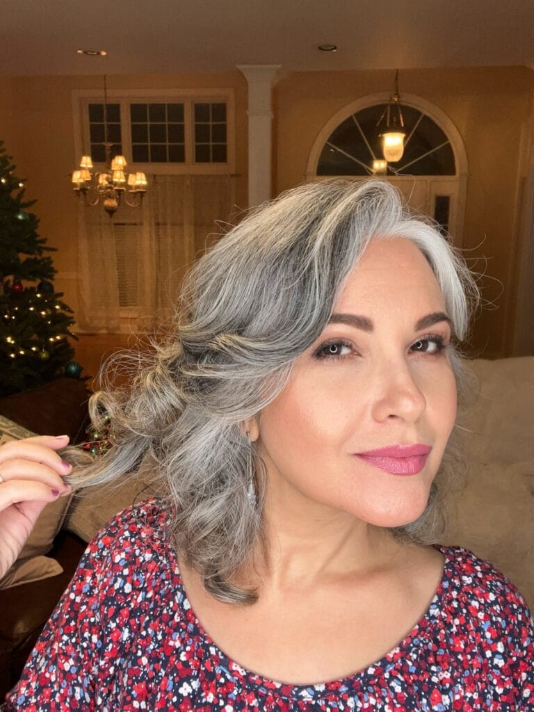Medium length silver layered bob with soft volume and smooth texture.