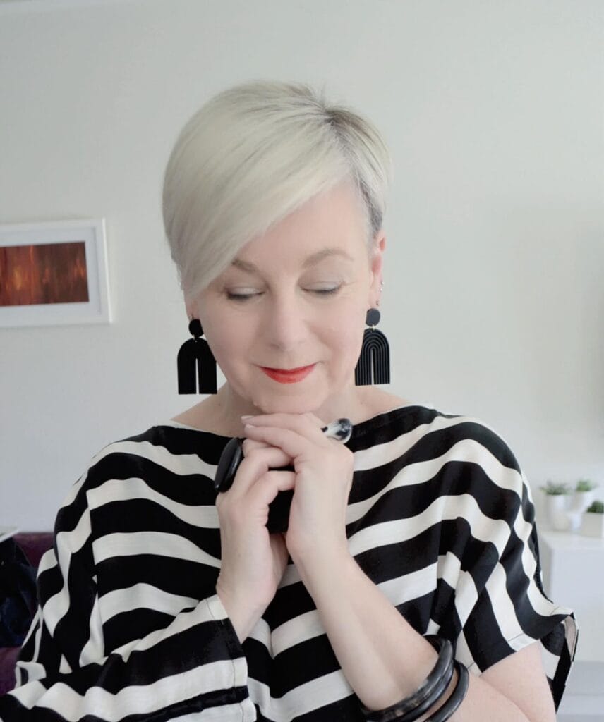 Short platinum layered pixie bob with a smooth finish and soft layers.