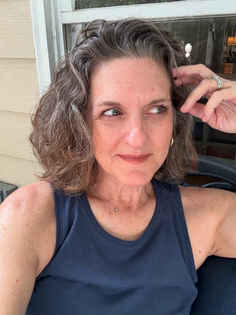 Medium length layered bob with soft waves and natural texture.