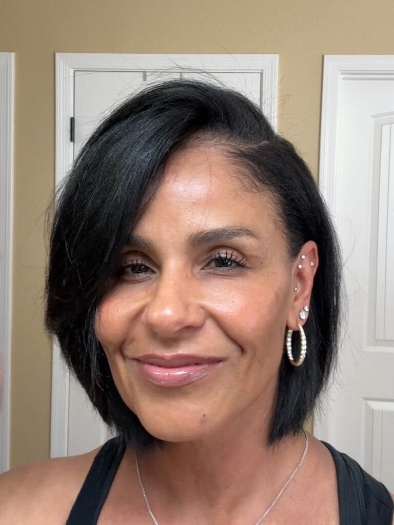 Chin length layered bob with a deep side part and smooth finish.