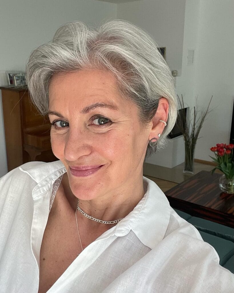 Short silver layered pixie bob with volume on top.