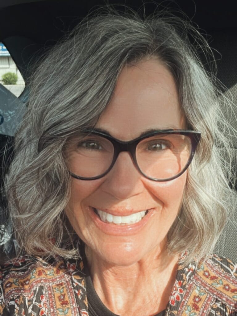 Silver layered bob with soft waves and natural volume.