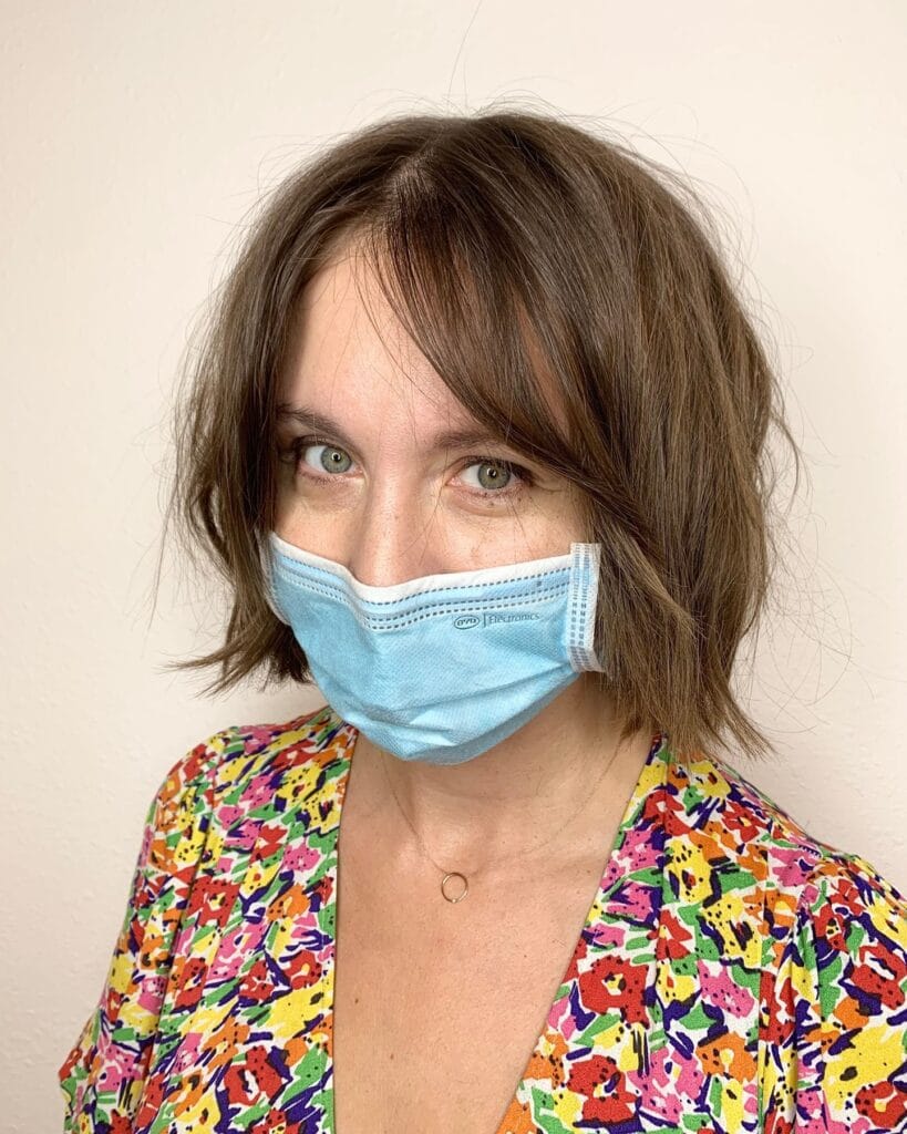 A tousled French bob with natural waves and a soft center part.