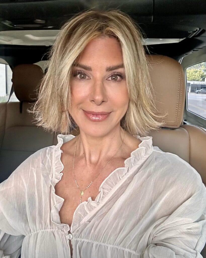 A rounded bob with soft blowout volume and light blonde color.