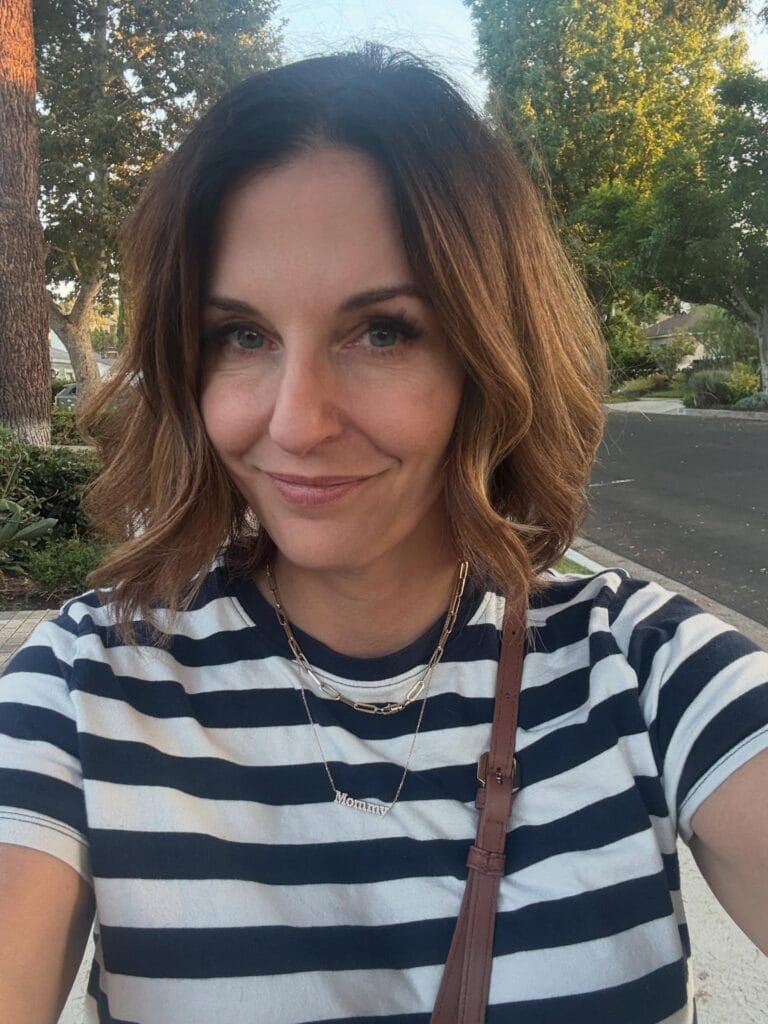A soft wavy messy bob with face framing highlights and natural brown tones.