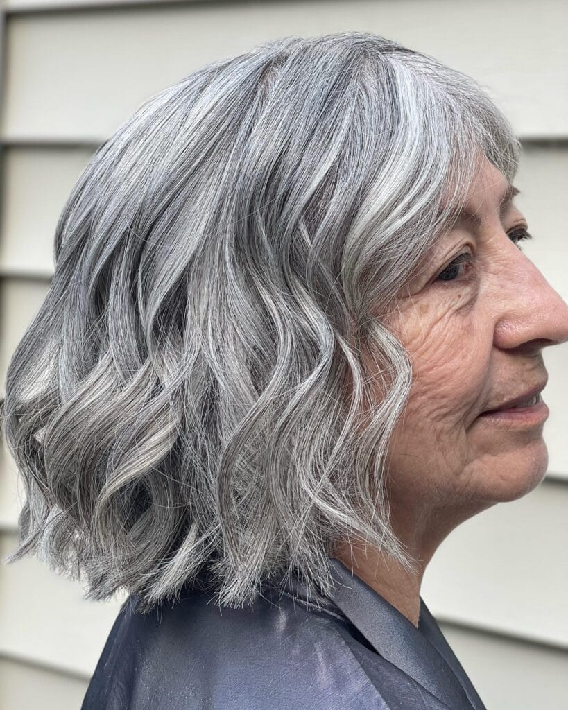 A wavy silver messy bob with defined texture and soft movement.