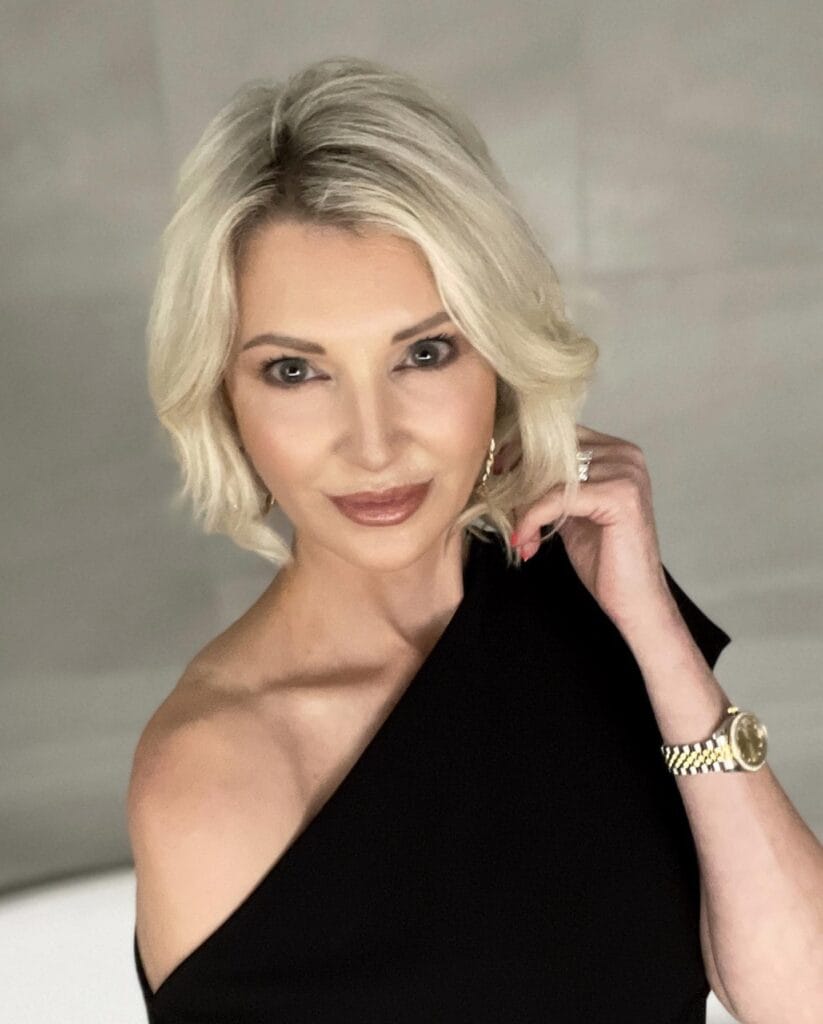 A polished layered bob with soft volume and light blonde tones.