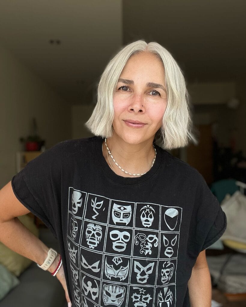 A sleek silver messy bob with a center part and smooth straight finish.