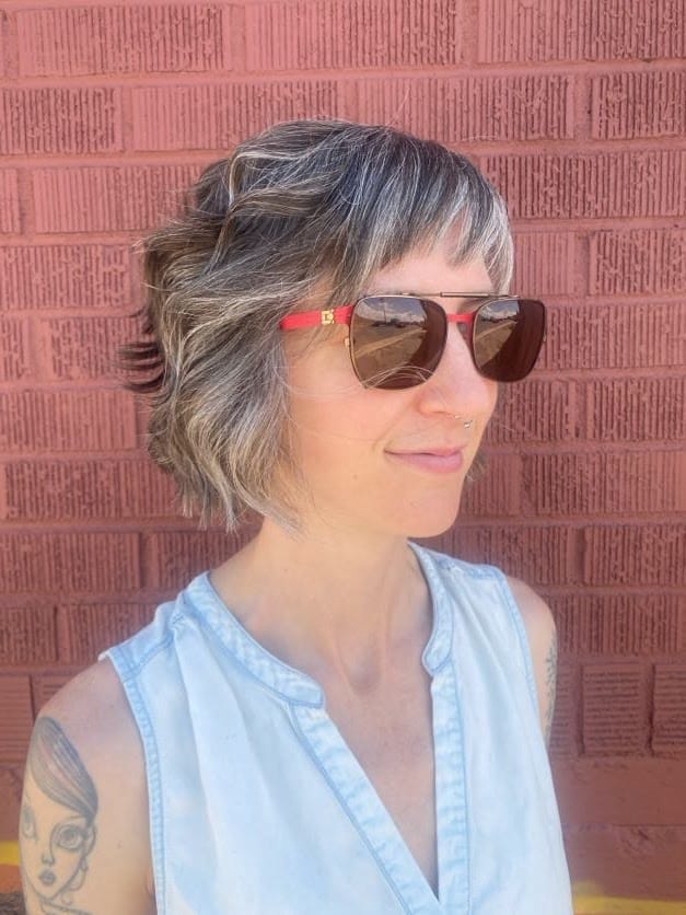 A textured messy bob with soft layers, subtle highlights, and a relaxed side profile.