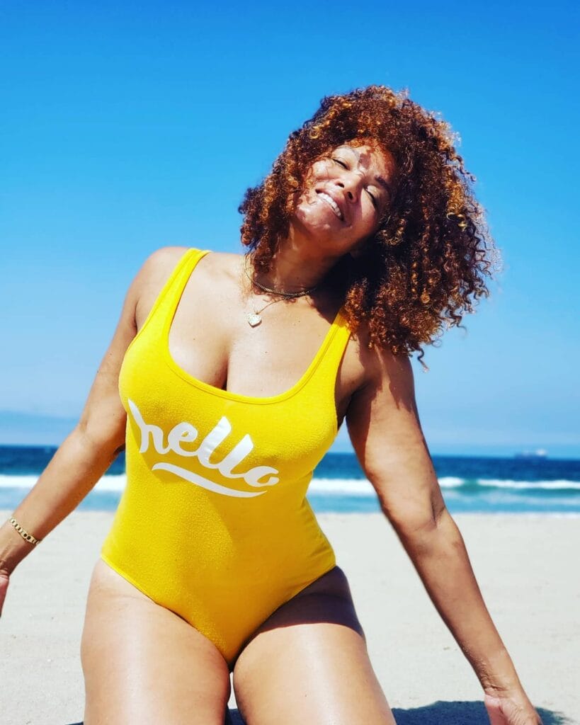 Shoulder length curly hair with soft beachy texture.