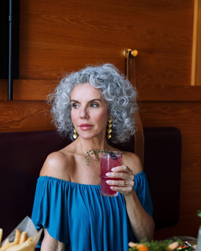 Short silver curly crop with soft volume and natural texture.