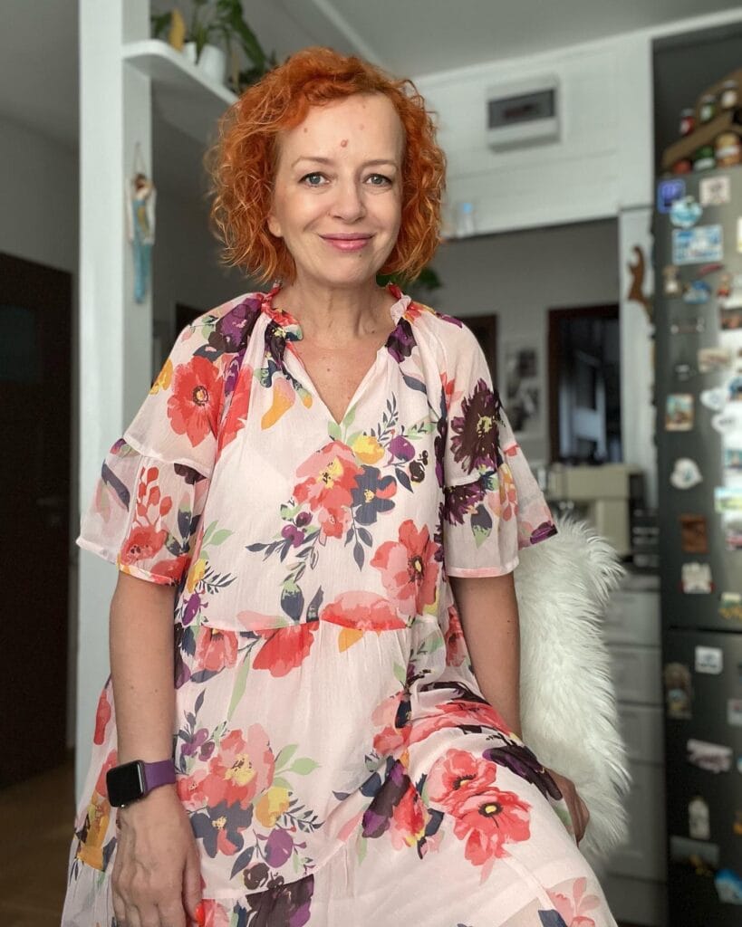 Short red curly bob with soft layers and textured curls.