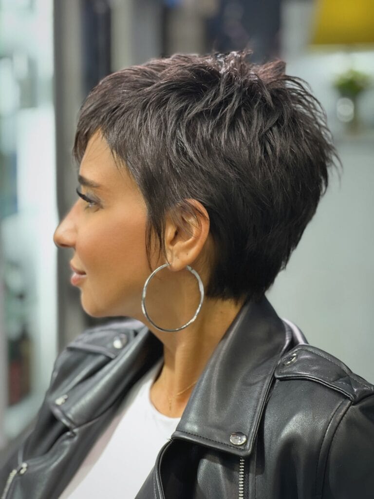 Short textured shaggy bob haircut with choppy layers and dark brunette color.