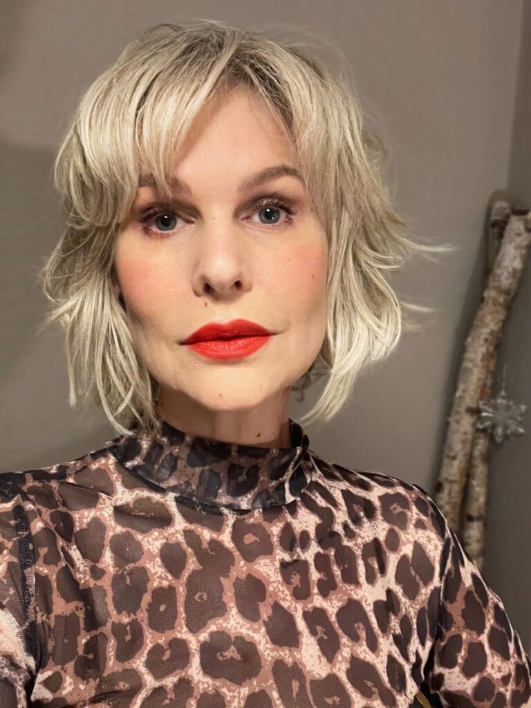 Blonde shaggy bob haircut with wispy layers and soft textured ends.