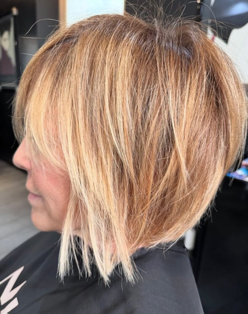 Choppy blonde shaggy bob haircut with layered texture and soft volume.