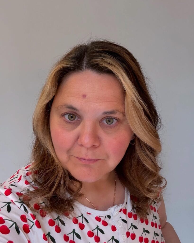 Shoulder length brown hair with soft loose waves and subtle layered texture.