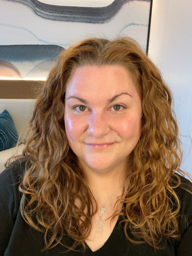 Long copper wavy hair with natural curls and soft layers worn past the shoulders.