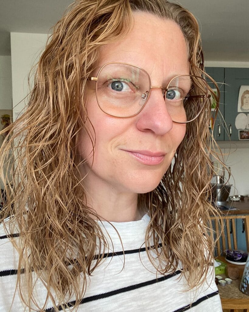 Shoulder length wavy hair with loose natural texture and soft layers.